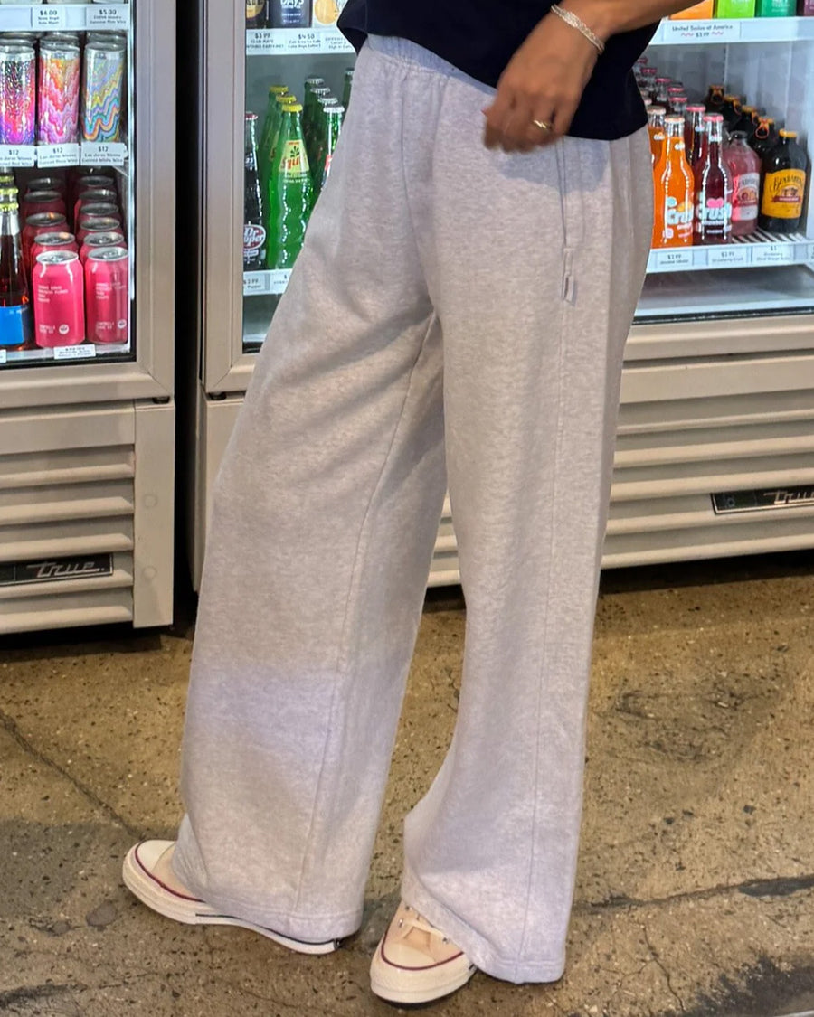 side view of model wearing relaxed heather grey sweatpants with side pockets