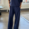 model wearing relaxed navy sweatpants with side pockets