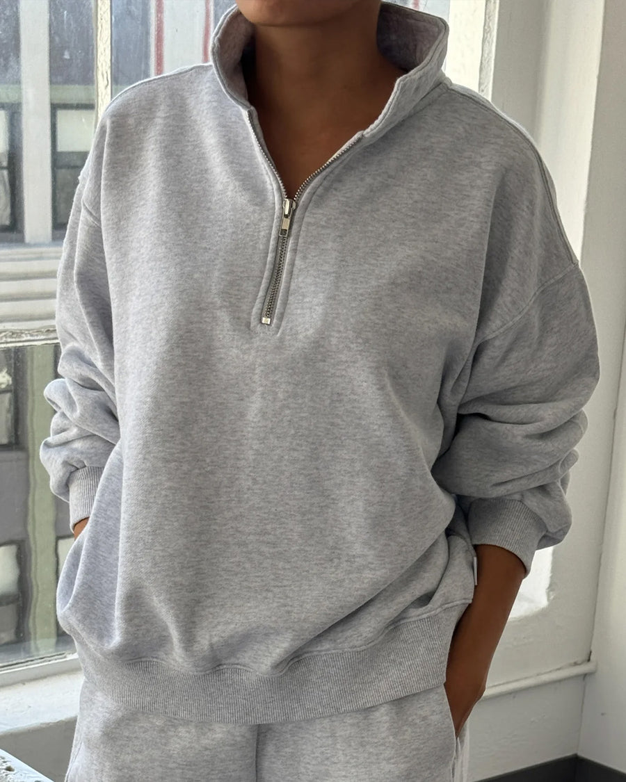 model wearing relaxed fit heather grey french terry quarter zip sweatshirt