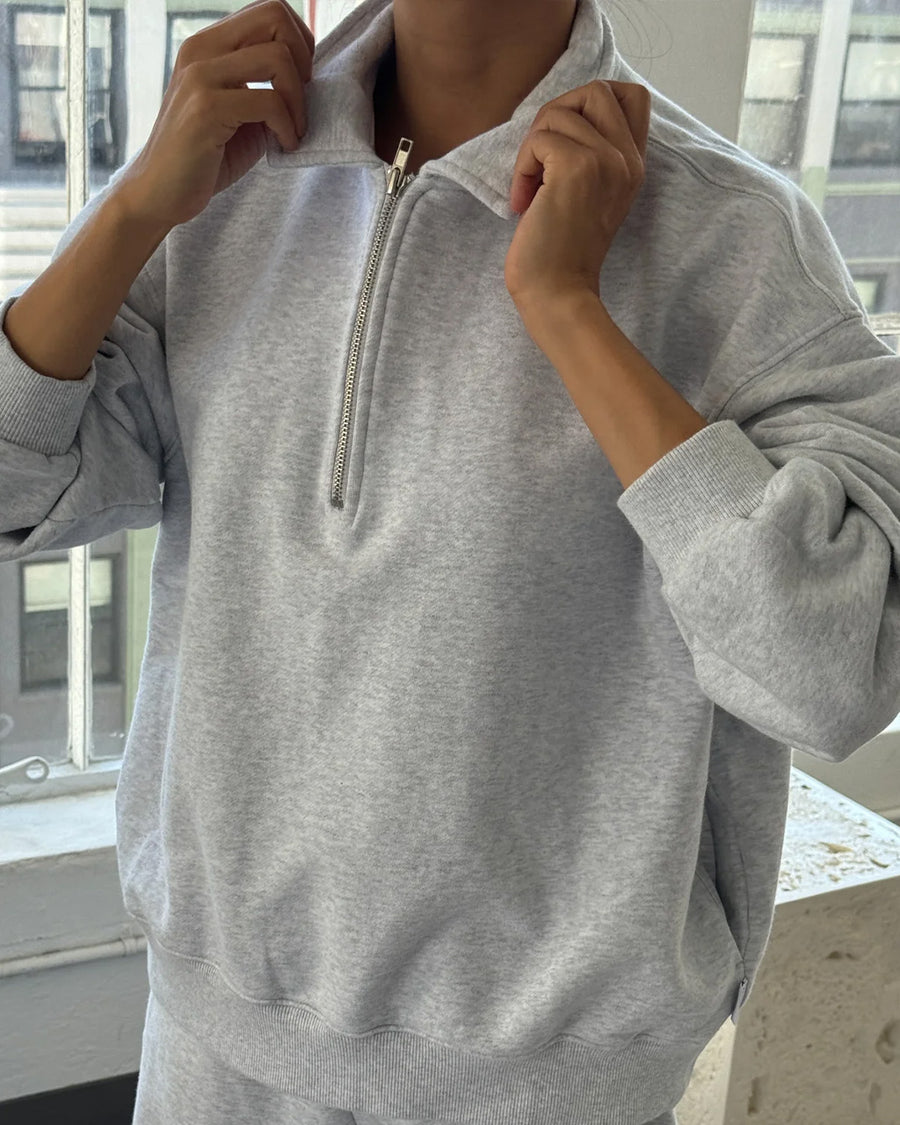 model wearing relaxed fit heather grey french terry quarter zip sweatshirt