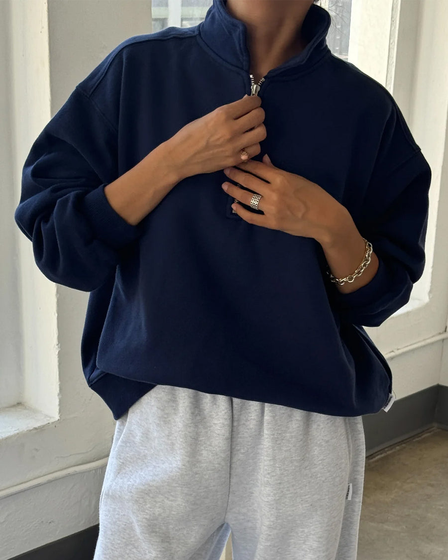 model wearing relaxed fit navy french terry quarter zip sweatshirt