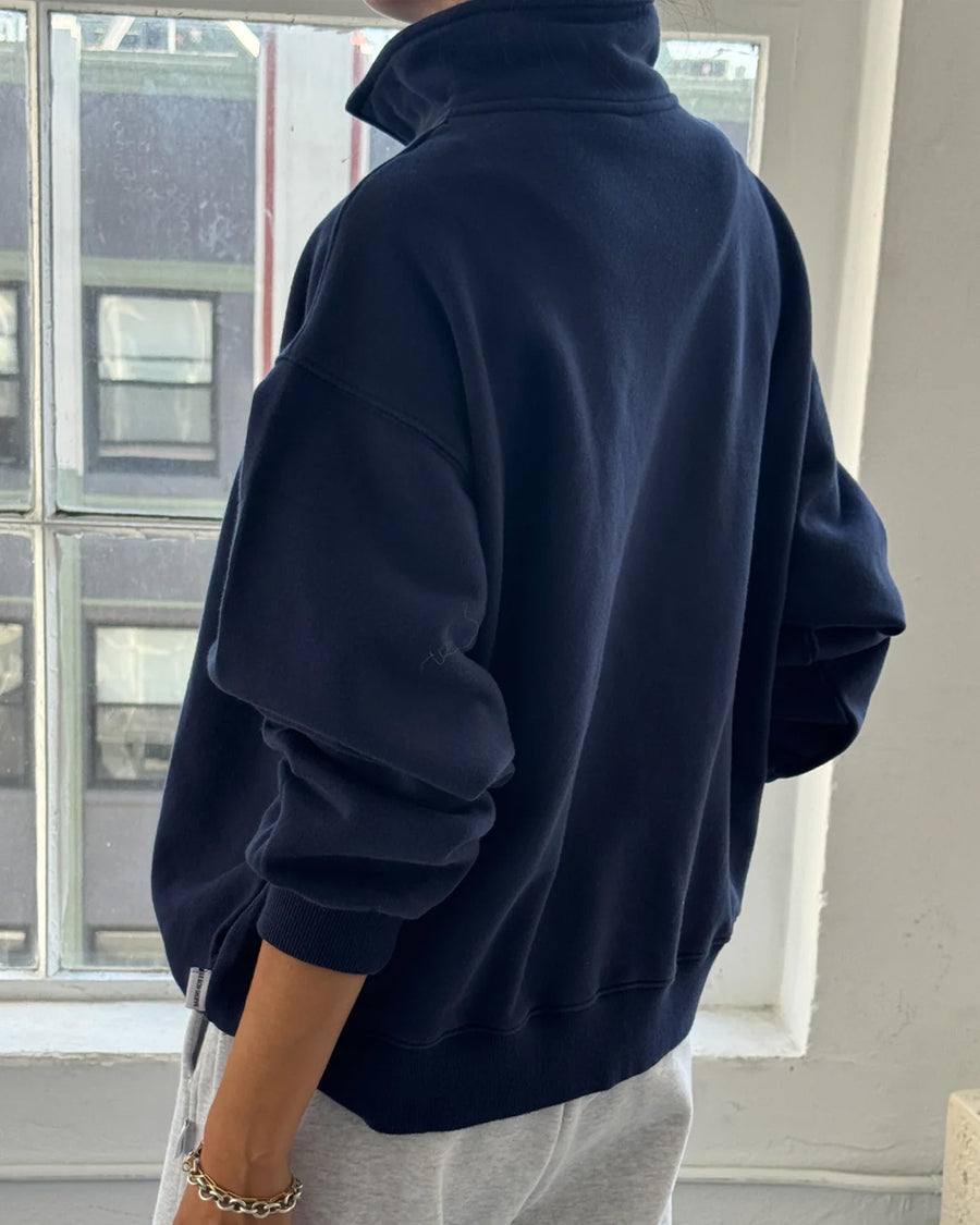 back view of model wearing relaxed fit navy french terry quarter zip sweatshirt