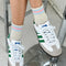 model wearing heather grey socks with light blue and light pink stripes on the top