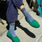 model wearing indigo socks with navy stripes on the top with shoes on