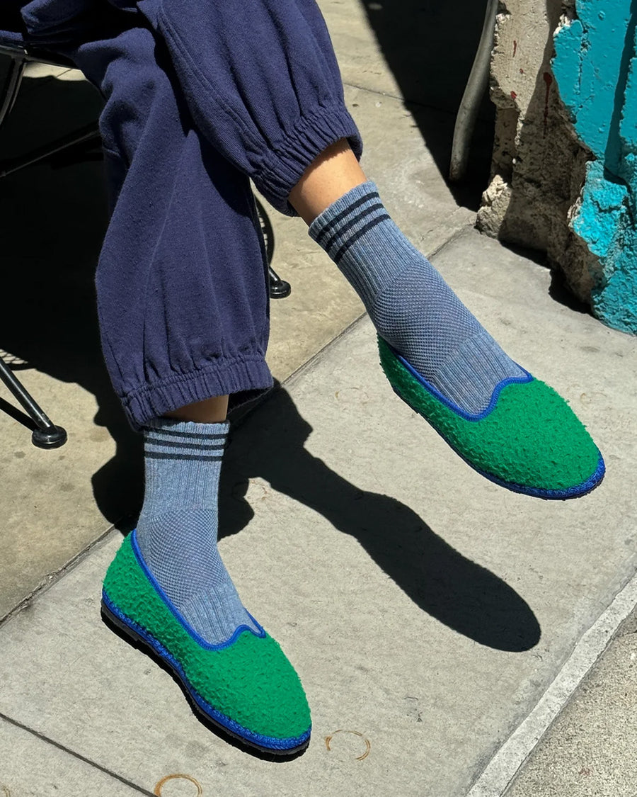 model wearing indigo socks with navy stripes on the top with shoes on