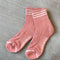 salmon high crew socks with three white stripes at the top