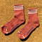 terracotta high crew socks with three white stripes at the top