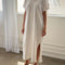 model wearing white short sleeve cotton maxi dress with side slits