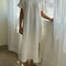 model wearing white short sleeve cotton maxi dress with side slits