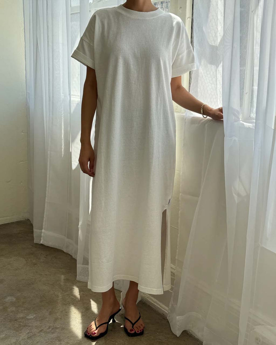 model wearing white short sleeve cotton maxi dress with side slits