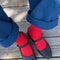 model wearing red ribbed high crew socks with black mary jane shoes