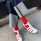 model wearing red ribbed high crew socks with white fisherman shoes