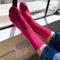 up close of model wearing fuchsia pink ribbed crew socks