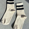 cream high crew socks with two thick black stripes at the top