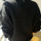 back view of model wearing v-neck mohair sweater in black