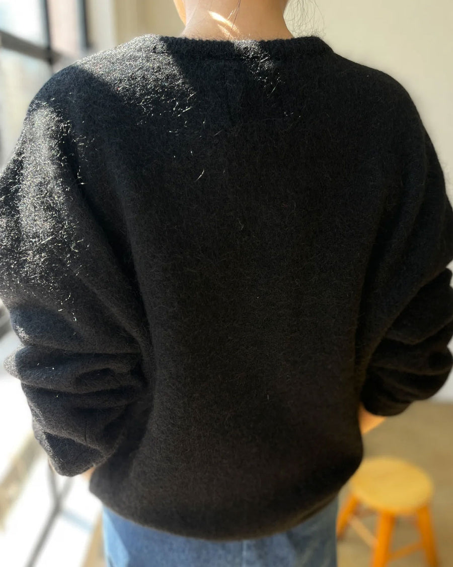 back view of model wearing v-neck mohair sweater in black