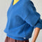 side view of model wearing v-neck mohair sweater in royal blue 