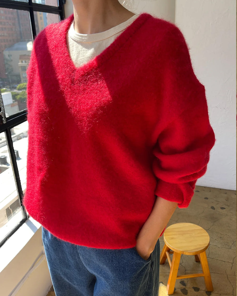 side view of model wearing red v-neck mohair sweater