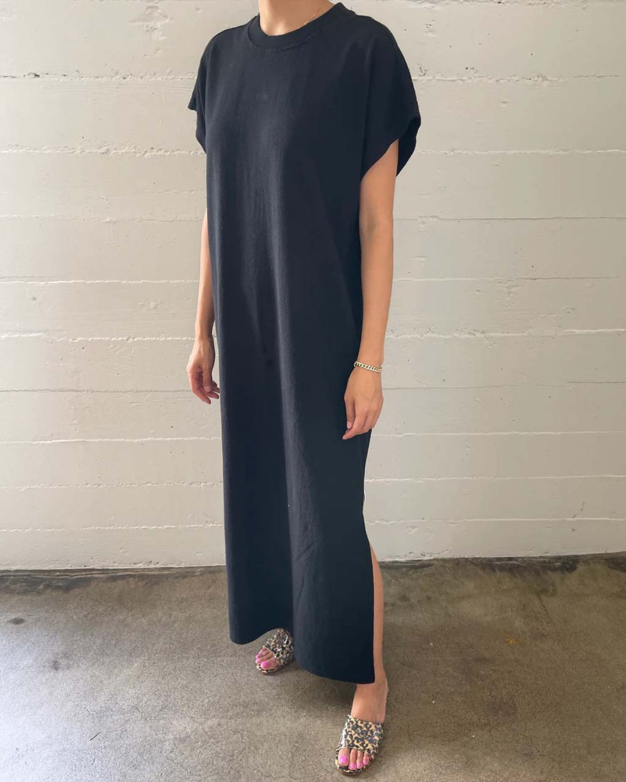 model wearing black maxi dress with slight cap sleeves and side slits