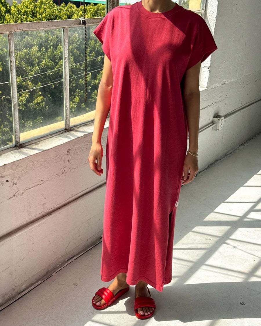 model wearing red maxi dress with slight cap sleeves and side slits