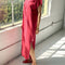 sideview of model wearing red maxi dress with slight cap sleeves and side slits