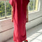 back view of model wearing red maxi dress with slight cap sleeves and side slits