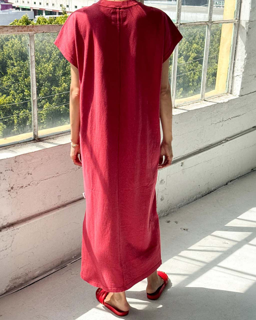 back view of model wearing red maxi dress with slight cap sleeves and side slits