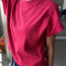 side view of model wearing red tee with slight muscle sleeves and slight crop