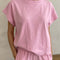 model wearing bubblegum pink tee with slight muscle sleeves and side slits