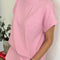 side view of model wearing bubblegum pink tee with slight muscle sleeves and side slits