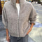 model wearing zipped taupe grey fluffy jacket with collar, zip front and patch pockets