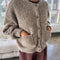 side view of model wearing buttoned taupe boucle cardigan with relaxed fit and front patch pockets