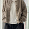 model wearing unbuttoned taupe boucle cardigan with relaxed fit and front patch pockets