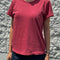 model wearing crayon red organic cotton tee with a vintage look and slight distressing on the neckline and arm holes