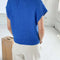 back view of model wearing bright blue sweater top with slight cap sleeves