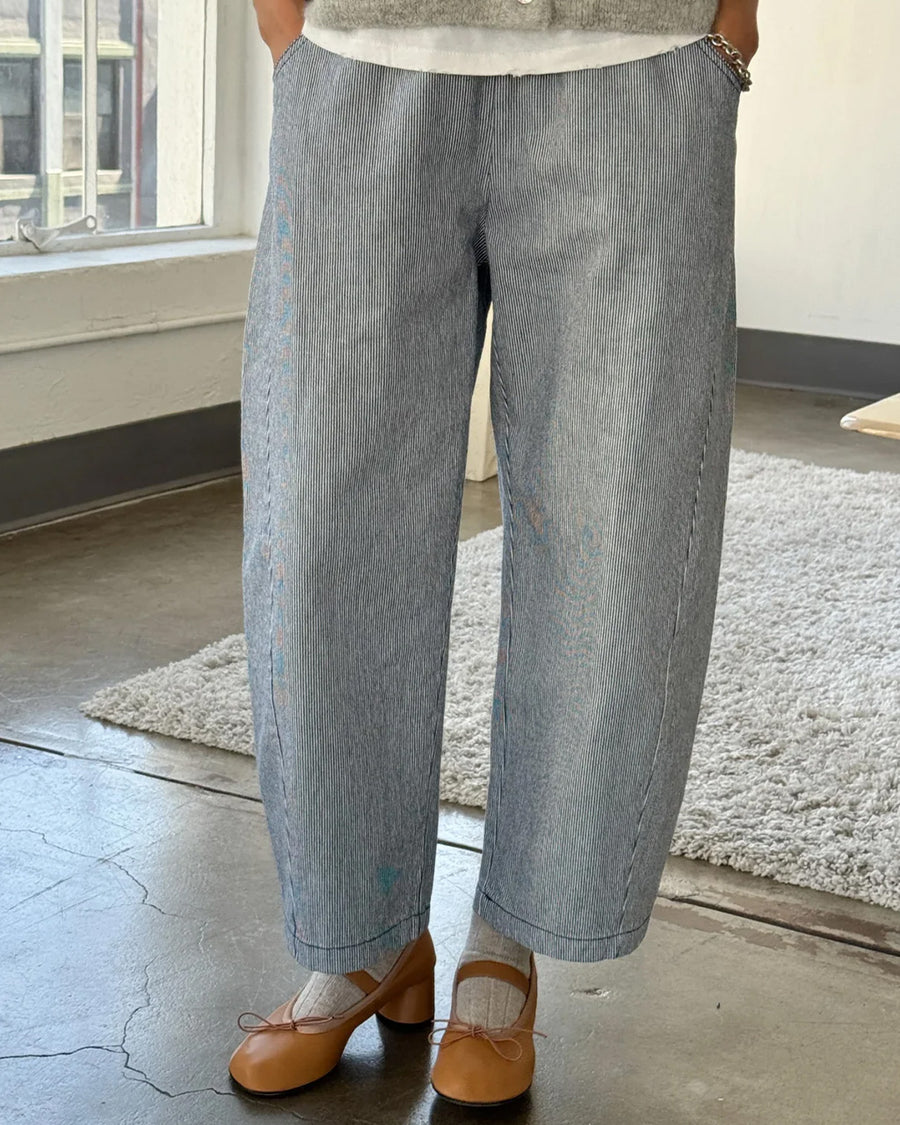 front view of model wearing thin blue and white pinstripe heavyweight cotton pants