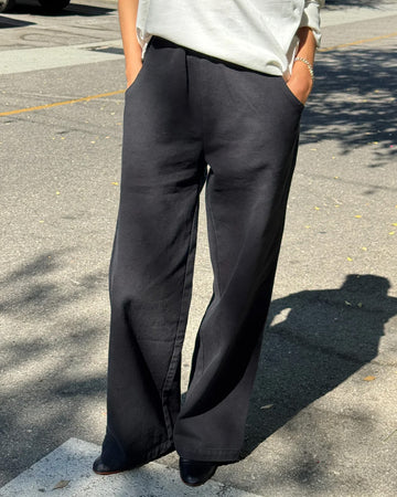 model wearing black relaxed fit cotton canvas pants with side pockets