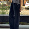 side view of model wearing black relaxed fit cotton canvas pants with side pockets