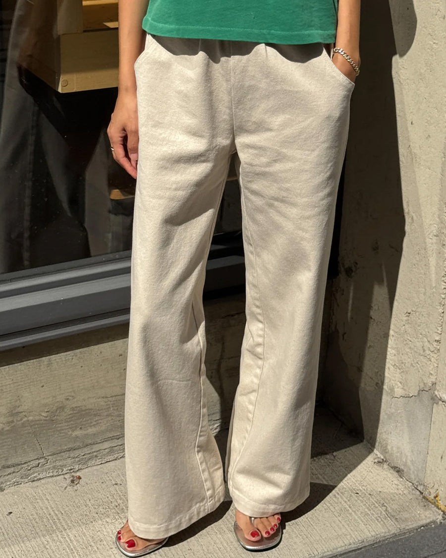 front view of model wearing cream (naturel) relaxed fit cotton canvas pants with side pockets