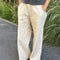 model wearing cream (naturel) relaxed fit cotton canvas pants with side pockets