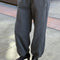 side view of model wearing dark grey (coal) french terry balloon pants with side pockets