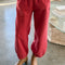 model wearing red french terry balloon pants with side pockets