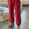 up close of model wearing red french terry balloon pants with side pockets