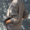 back view of model wearing dark grey (coal) quarter zip french terry pullover sweatshirt