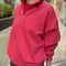 side view of model wearing red quarter zip french terry pullover sweatshirt