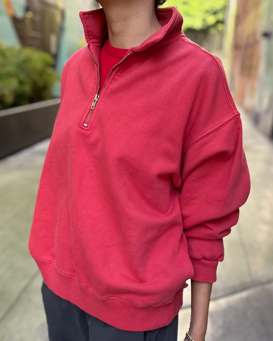 side view of model wearing red quarter zip french terry pullover sweatshirt