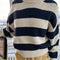 model wearing navy and white thick stripe sweater with mock neckline