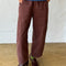 model wearing chocolate arc pants with side pockets and side insert