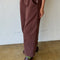 side view of model wearing chocolate arc pants with side pockets and side insert