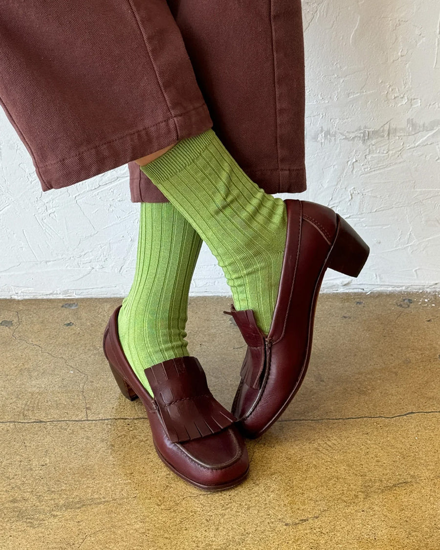 model wearing cactus green ribbed crew socks